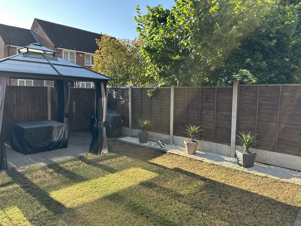 A gazebo and potted plants in a garden at 37 Hanbury Gardens Colchester