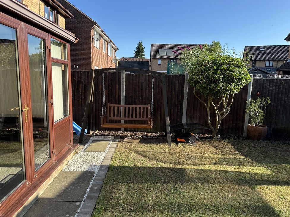 A garden with a swing and a tree at 37 Hanbury Gardens, Colchester