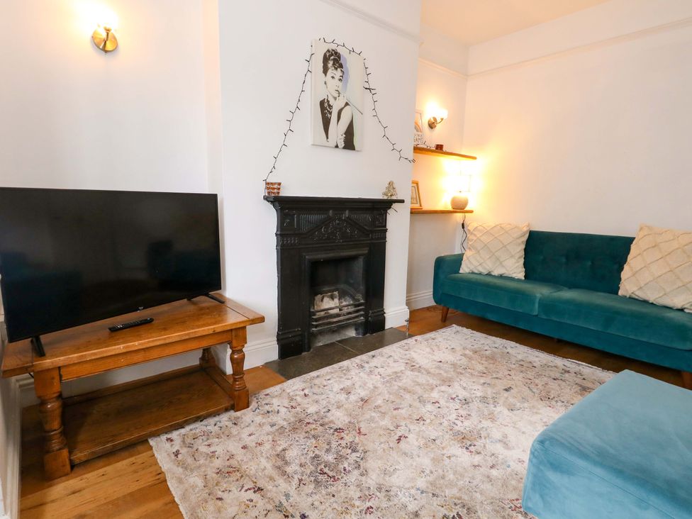 A living room with a television and a sofa at Garden Retreat in Swanage