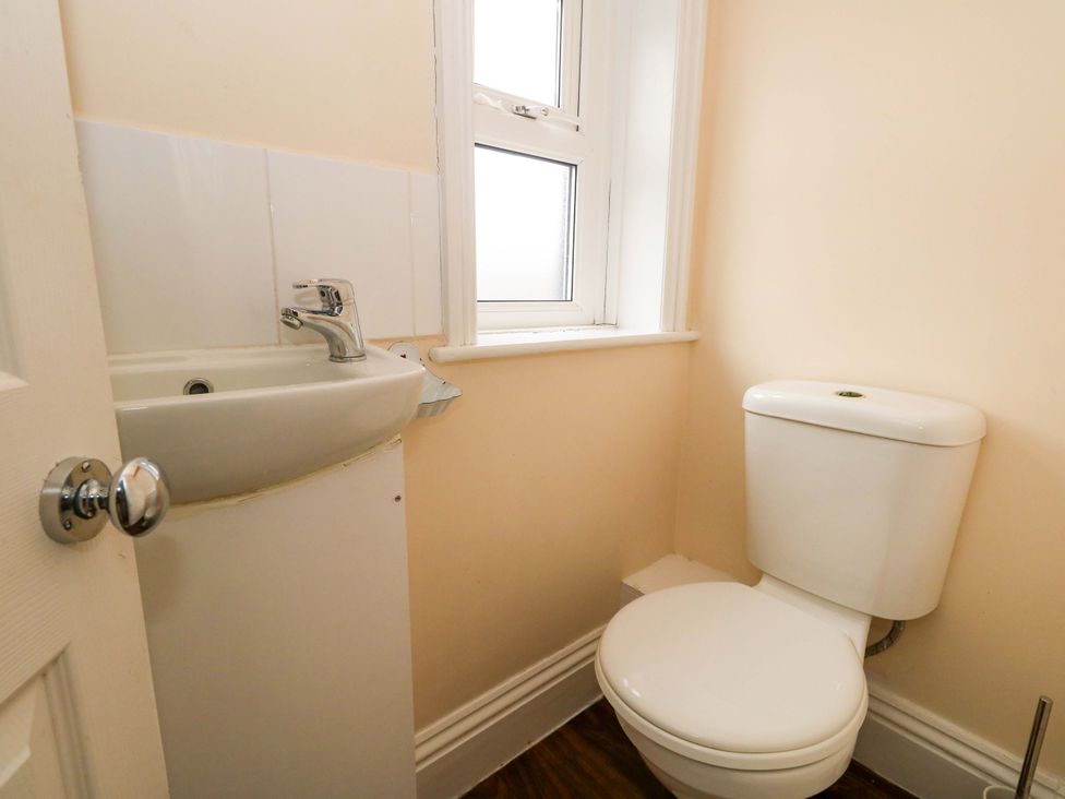 A bathroom with a sink and a toilet at Garden Retreat in Swanage