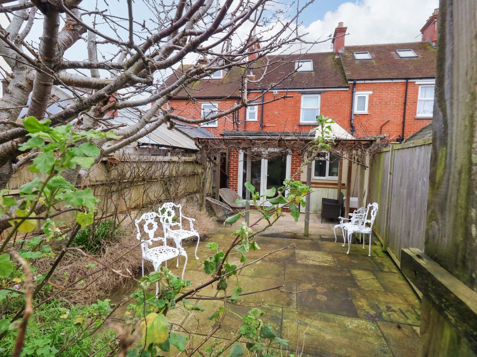 A garden with chairs and a table at Garden Retreat in Swanage