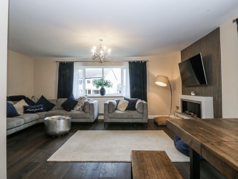A living room with a sofa, coffee table and television at Tyn Y Coed