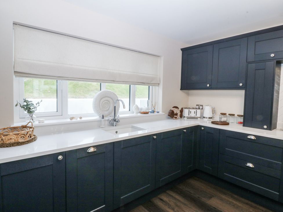 A kitchen with sink and appliances at Tyn Y Coed