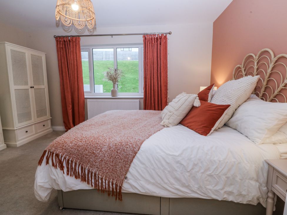 A bedroom with a bed and curtains at Tyn Y Coed 