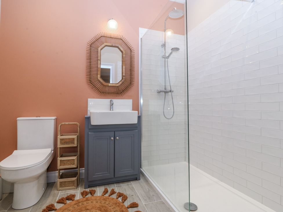 A bathroom with a toilet, sink, and shower at Tyn Y Coed