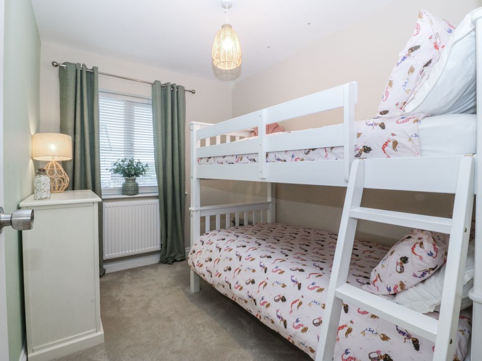 A bedroom with a bunk bed and lamp at Tyn Y Coed in 