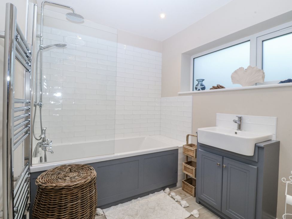 A bathroom with bathtub, shower and sink at Tyn Y Coed in 