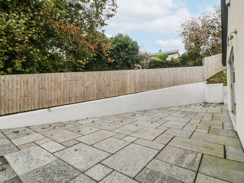 An outdoor area with paving stones and a fence at Tyn Y Coed