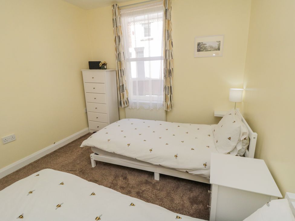 A bedroom with two beds and a dresser at Number 33 in Scarborough