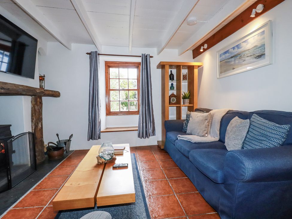 A living room with a sofa and coffee table at Rose Cottage in Falmouth