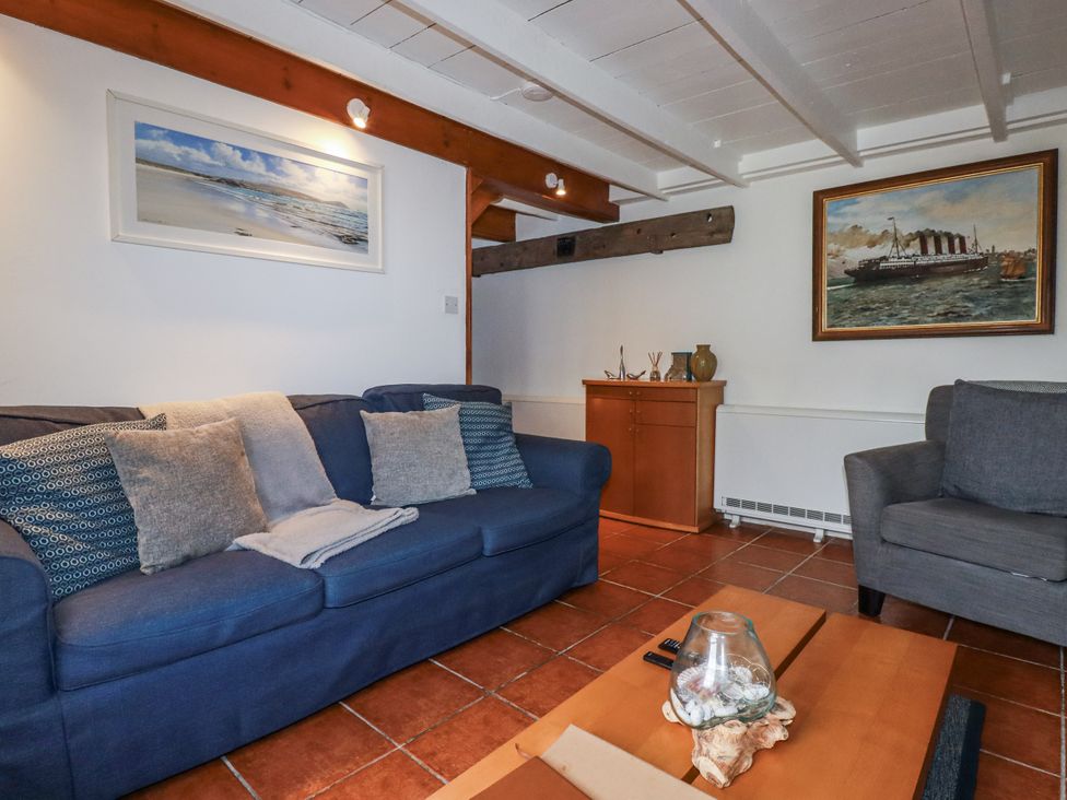 A living room with a sofa and coffee table at Rose Cottage in Falmouth