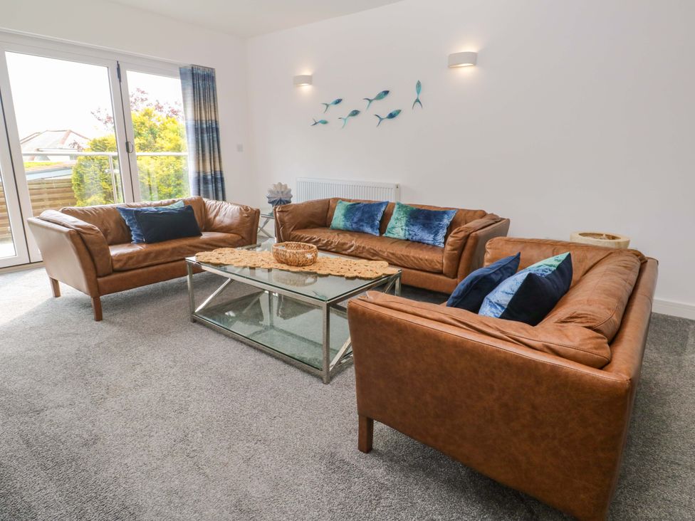 A living room with sofas and a coffee table at Miramar in St. Ives