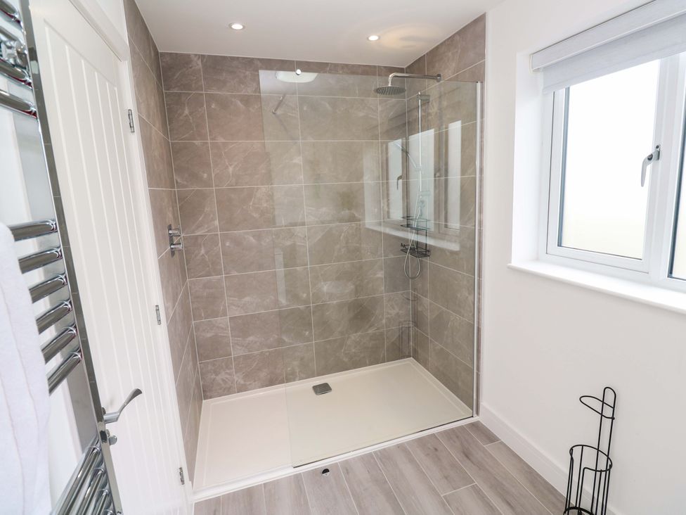A bathroom with a shower and towel radiator at Miramar in St. Ives