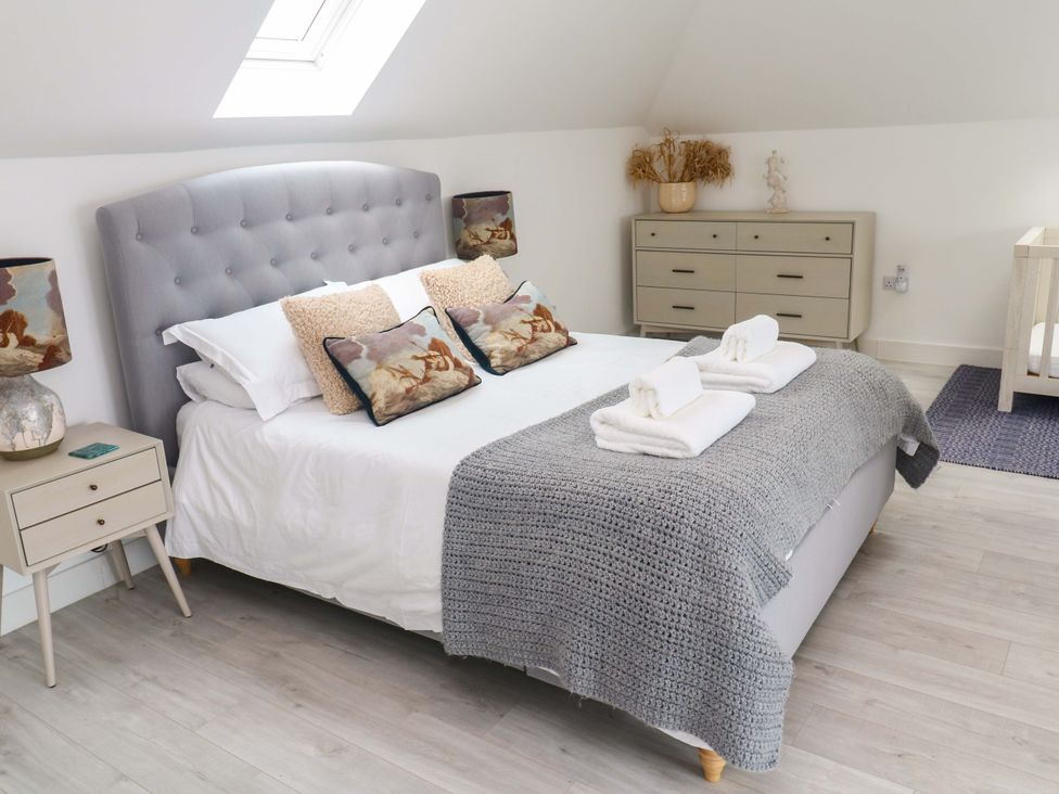 A bedroom with a bed and nightstand at Miramar in St. Ives
