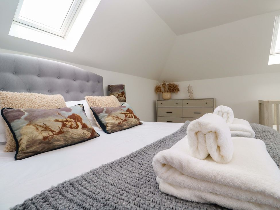 A bedroom with a bed and decorative pillows at Miramar St. Ives