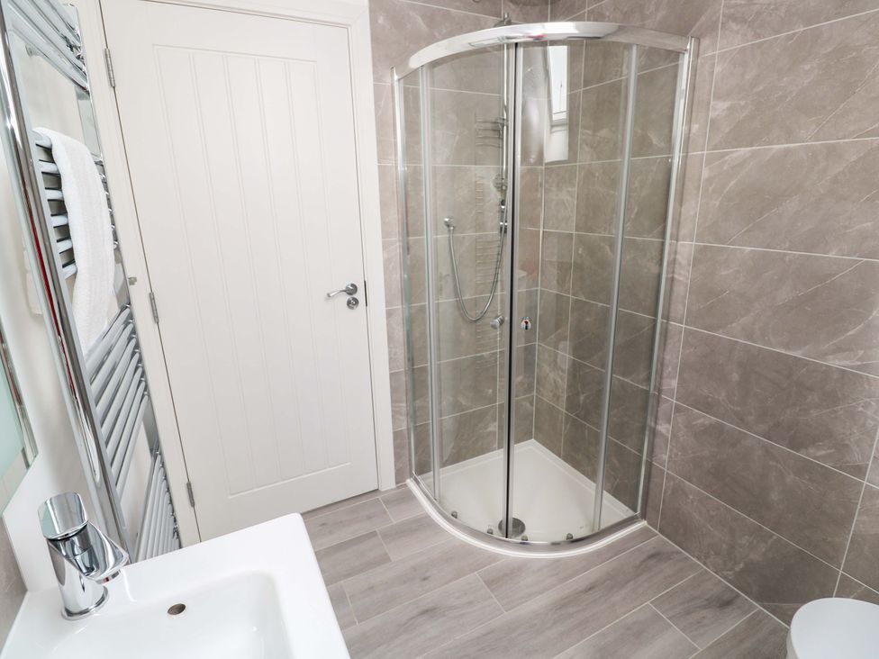 A bathroom with a shower and sink at Miramar, St. Ives