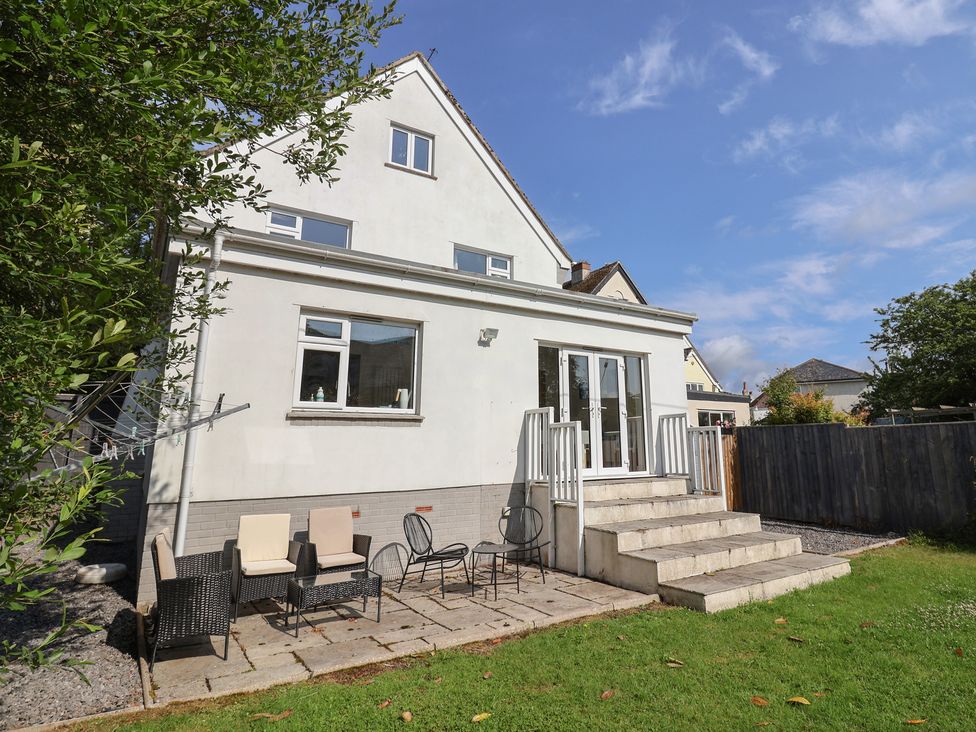 A patio with chairs and steps at 3 Grange Villas Charmouth