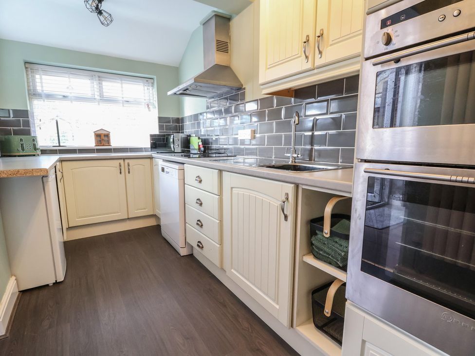 A kitchen with cabinets and appliances at 57 Broadway West in Chester