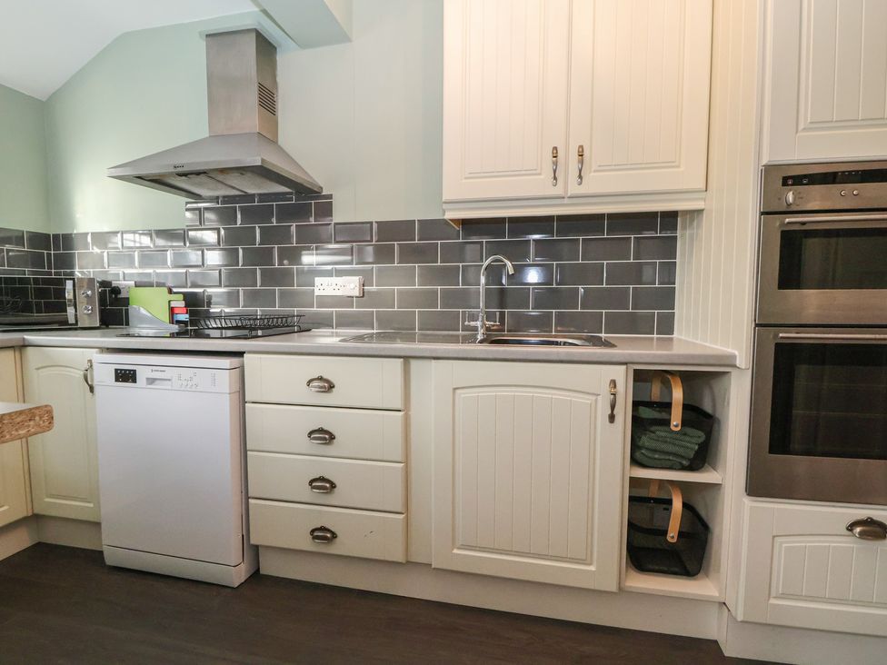 A kitchen with cabinets and appliances at 57 Broadway West in Chester