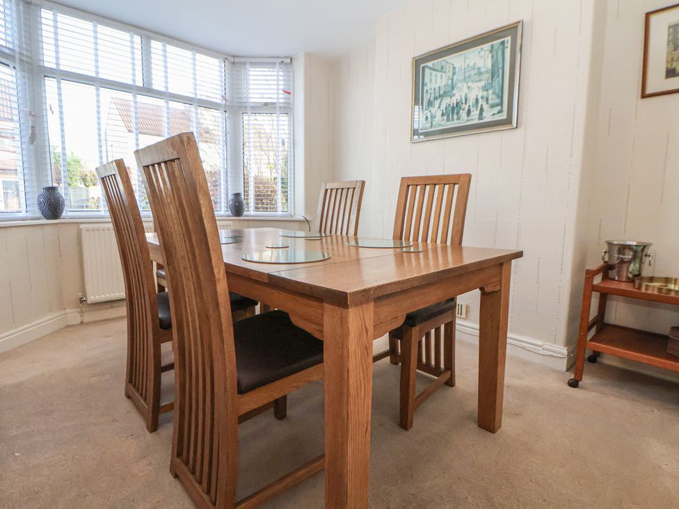 A dining room with a wooden dining table and chairs at 57 Broadway West in Chester