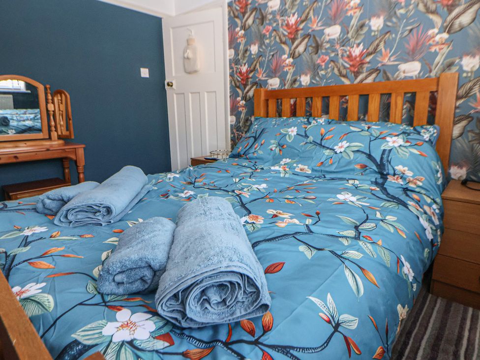 A bedroom with a bed and a mirror at 57 Broadway West in Chester