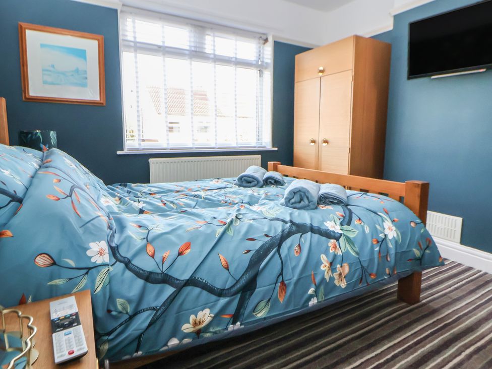 A bedroom with a bed and wardrobe at 57 Broadway West Chester