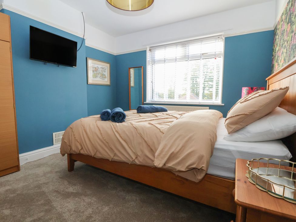 A bedroom with a bed and television at 57 Broadway West in Chester