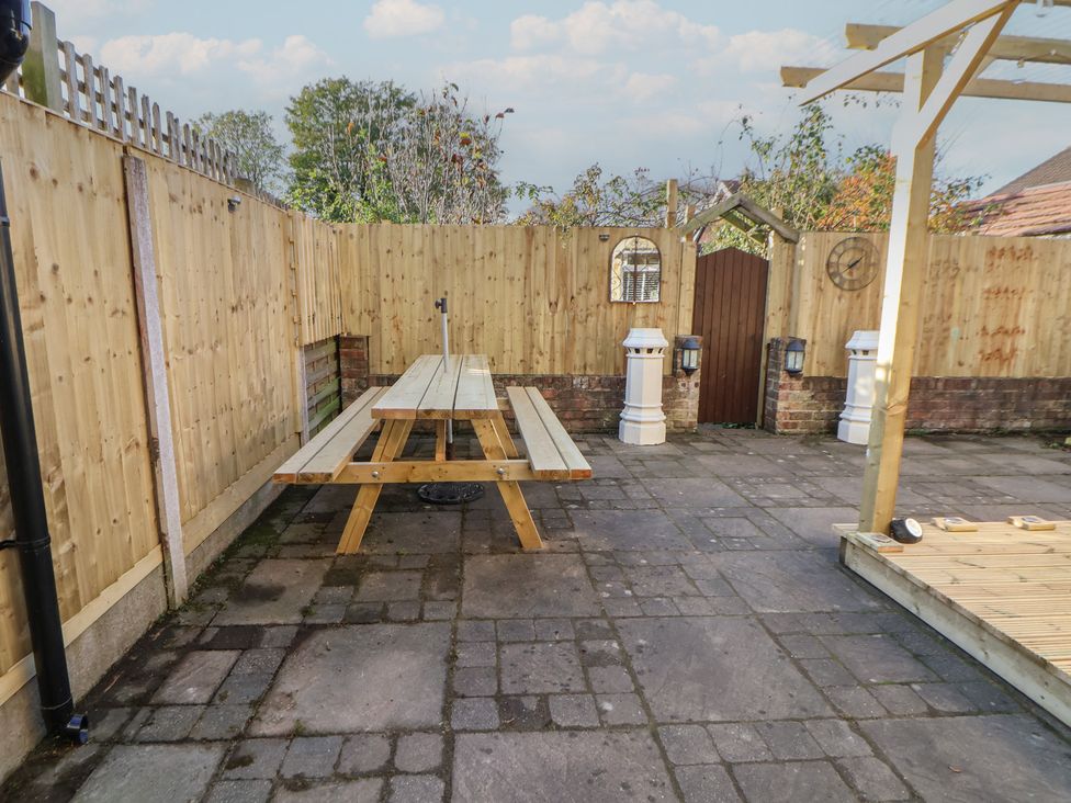 A garden area with a wooden table and fence at 57 Broadway West Chester