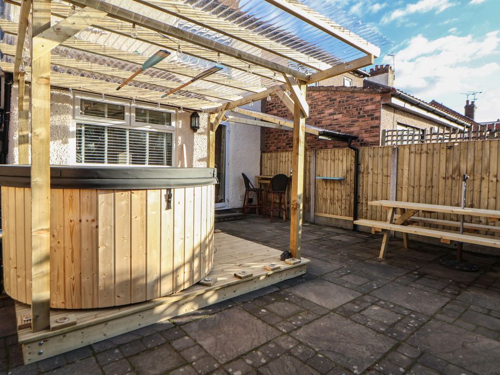 A garden with a hot tub and seating area at 57 Broadway West Chester