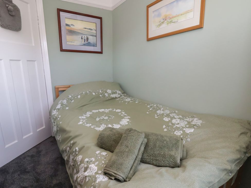 A bedroom with a bed and towels at 57 Broadway West Chester