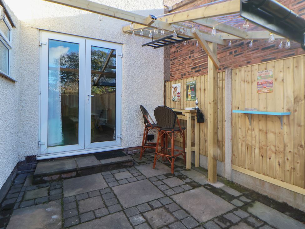 A patio area with bar stools and sliding doors at 57 Broadway West Chester