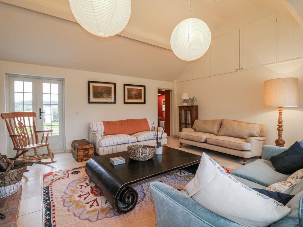 A living room with furniture and a table at Gapstile in Abbots Bromley