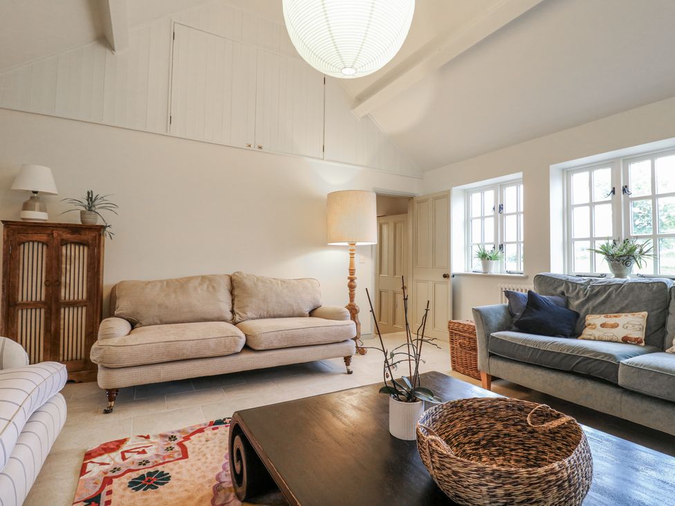 A living room with sofas and a table at Gapstile in Abbots Bromley