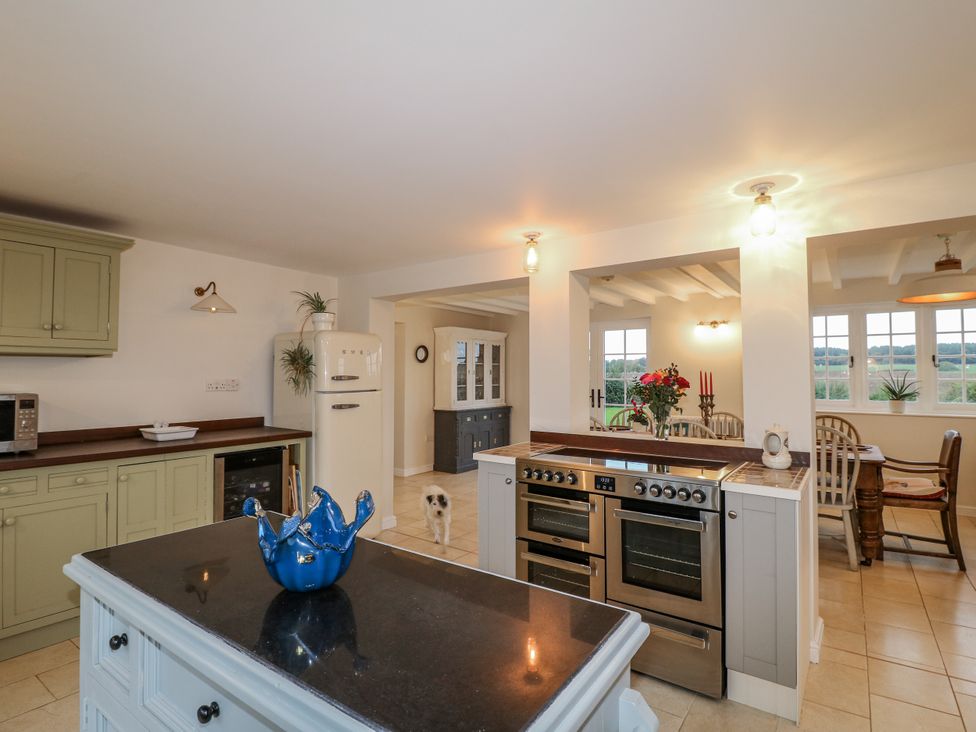 A kitchen with appliances and a table at Gapstile in Abbots Bromley