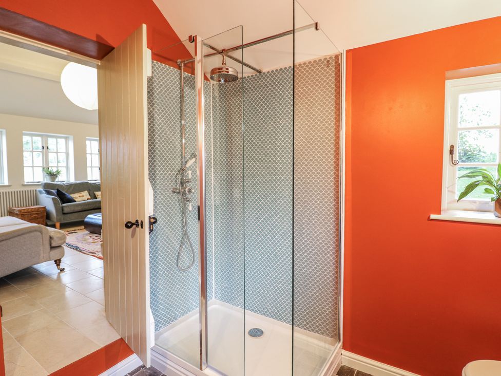 A shower with glass enclosure in a bathroom at Gapstile in Abbots Bromley