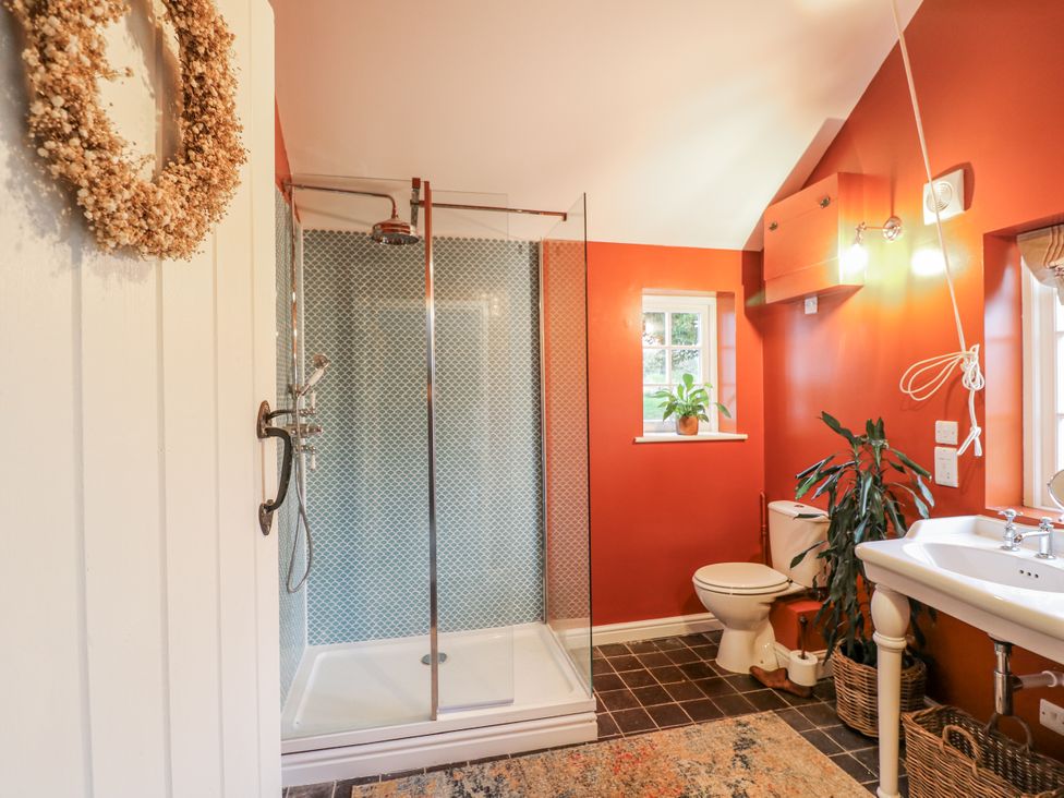 A bathroom with a shower, toilet, and sink at Gapstile in Abbots Bromley