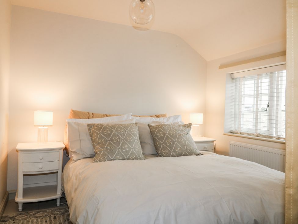 A bedroom with a bed and nightstands at Gapstile in Abbots Bromley