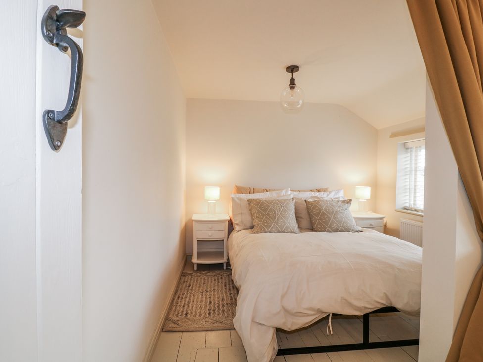 A bedroom with a bed and nightstands at Gapstile in Abbots Bromley