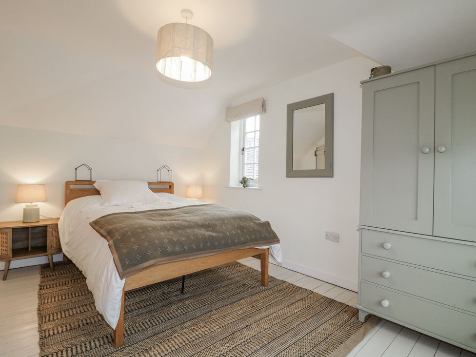 A bedroom with a bed and wardrobe at Gapstile in Abbots Bromley