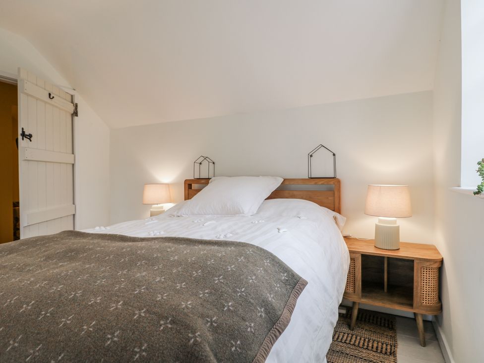 A bedroom with a bed and nightstand at Gapstile in Abbots Bromley