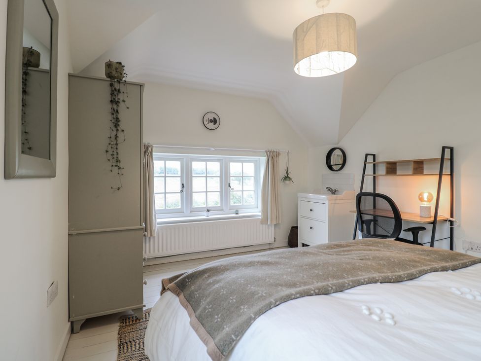 A bedroom with a bed and a desk at Gapstile in Abbots Bromley