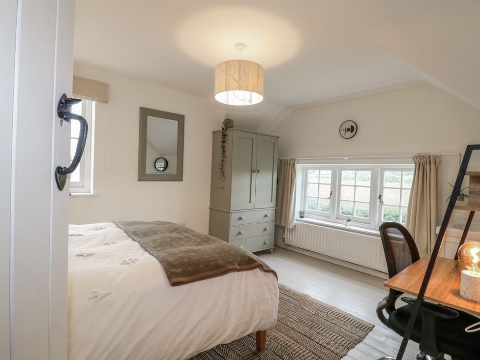 A bedroom with a bed and desk at Gapstile in Abbots Bromley