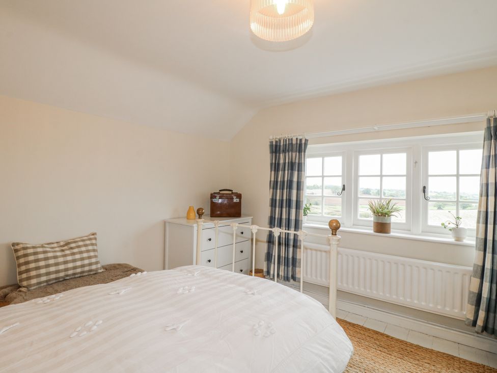 A bedroom with a bed and dresser at Gapstile in Abbots Bromley