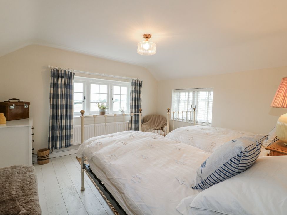 A bedroom with two beds and a window at Gapstile in Abbots Bromley