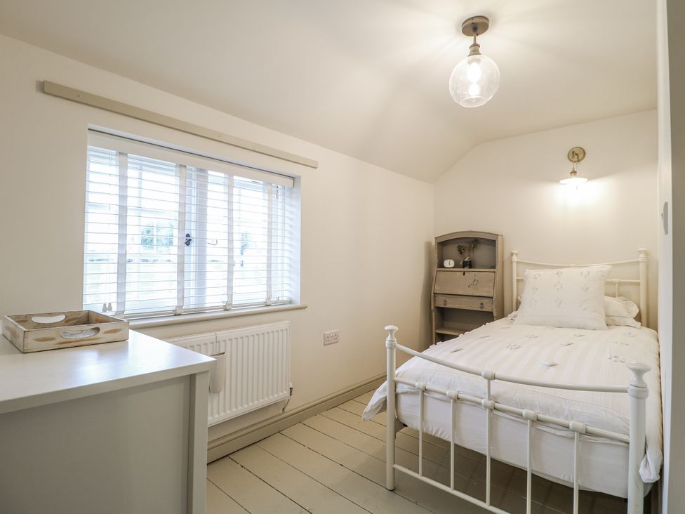A bedroom with a bed and a window at Gapstile in Abbots Bromley