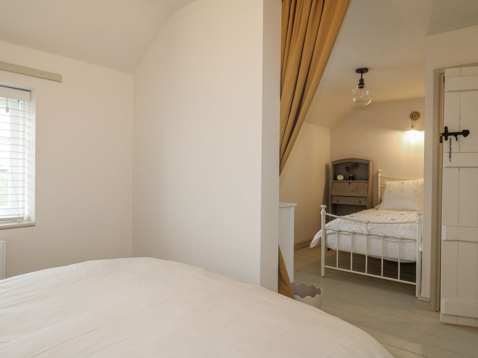 A bedroom with two beds and a curtain at Gapstile in Abbots Bromley