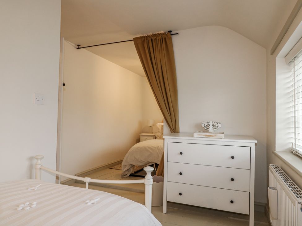 A bedroom with a bed and a dresser at Gapstile in Abbots Bromley
