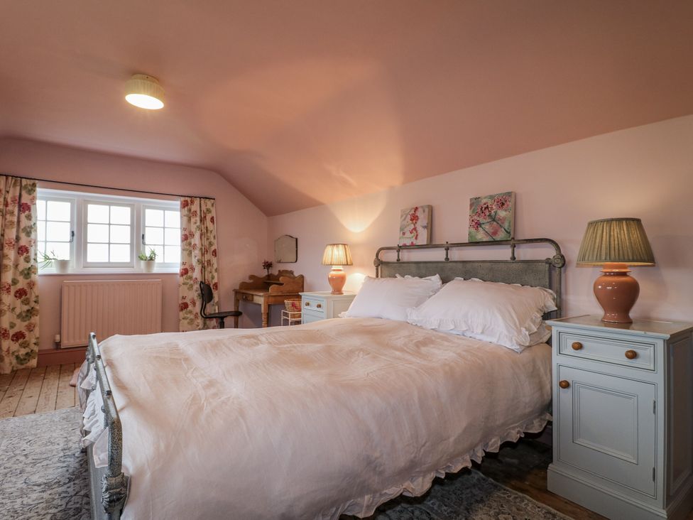 A bedroom with a bed and nightstands at Gapstile in Abbots Bromley