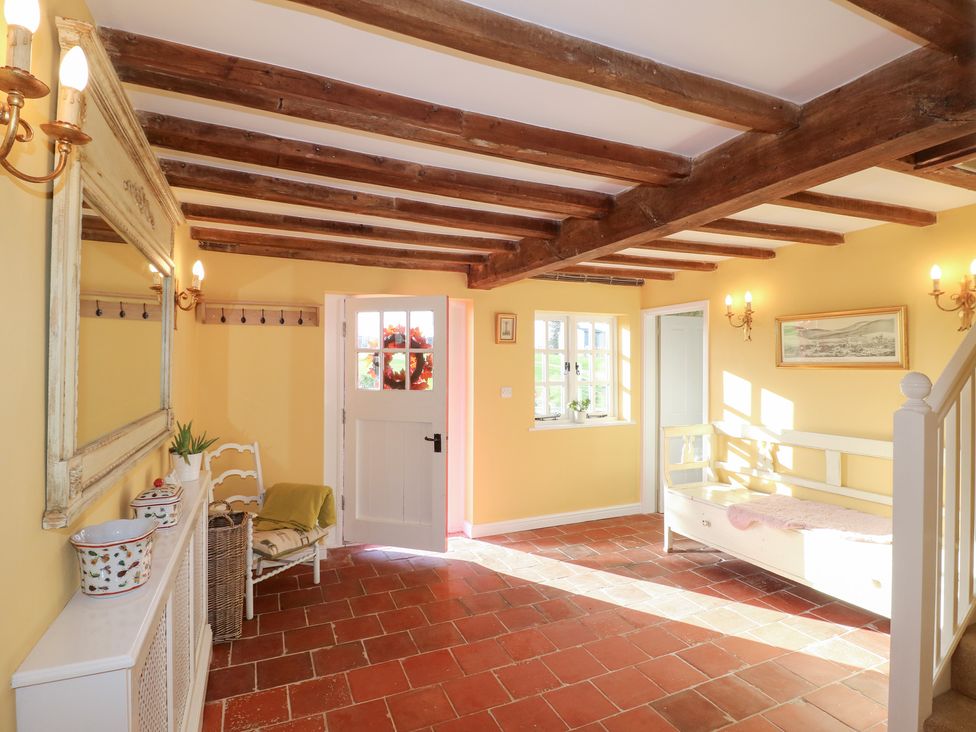 A hallway with a door and window at Gapstile in Abbots Bromley