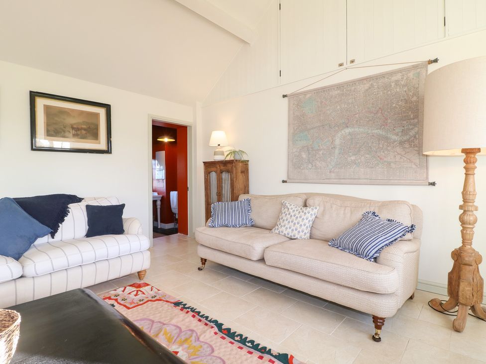 A living room with a sofa and map on the wall at Gapstile in Abbots Bromley